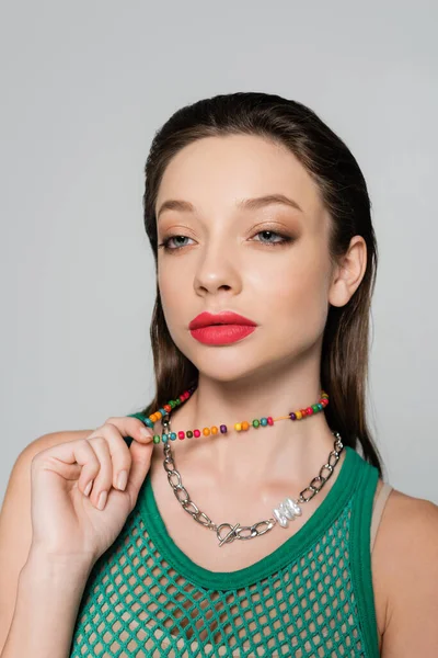 Stylish Model Red Lips Pulling Beads Necklace Isolated Grey — стоковое фото