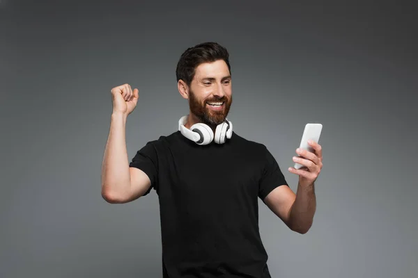 Excited Bearded Man Wireless Headphones Using Smartphone Isolated Grey — Stock fotografie