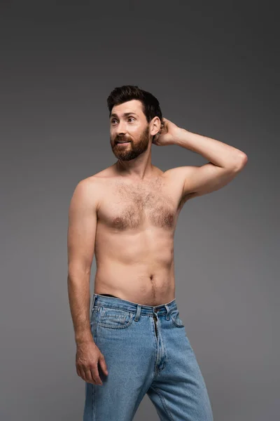 Puzzled Shirtless Man Beard Standing Denim Jeans Isolated Grey — Fotografia de Stock