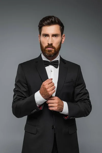 Bearded Man Black Tuxedo Bow Tie Adjusting Sleeve Shirt Isolated — Fotografia de Stock