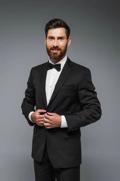 Bearded Man Black Tuxedo Bow Tie Smiling Isolated Grey — Fotografia de Stock