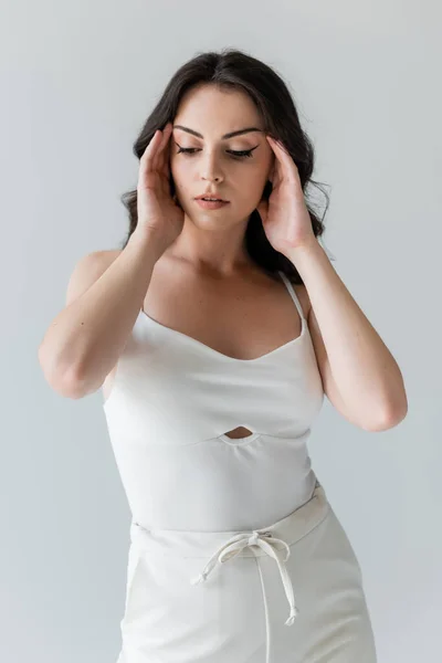 Brunette Model Touching Forehead Looking Away Isolated Grey — Stockfoto