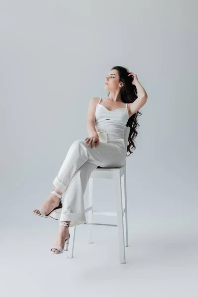 Full Length Young Model White Clothes Heels Sitting Chair Grey — Fotografia de Stock