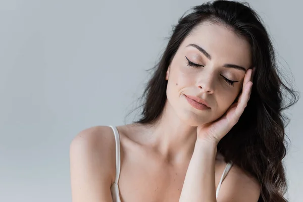 Portrait Brunette Woman Closed Eyes Touching Face Isolated Grey — Stockfoto