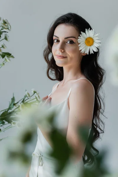 Young Woman White Clothes Standing Blurred Flowers Isolated Grey — Zdjęcie stockowe