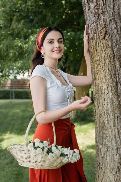 Cheerful Woman Blouse Skirt Holding Basket Flowers Tree Park — Foto de Stock