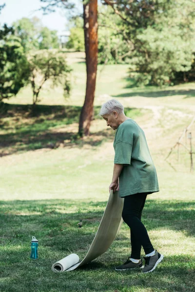 Full Length Senior Woman Holding Fitness Mat Sports Bottle Grass — Photo