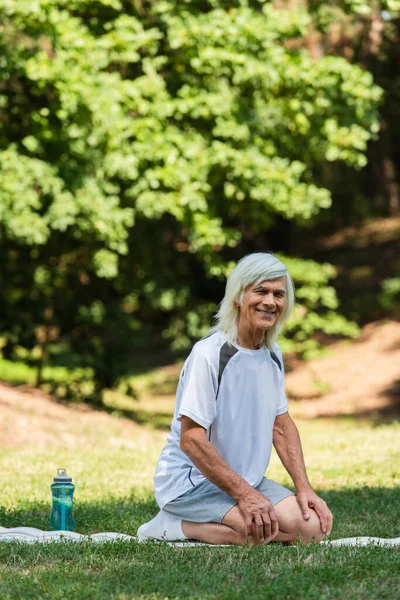 Full Length Happy Senior Man Sportswear Sitting Fitness Mat Green — Stockfoto