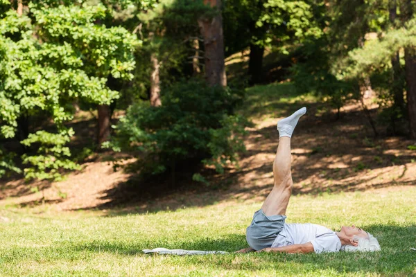 Full Length Senior Man Sportswear Doing Shoulder Stand Fitness Mat — Stockfoto