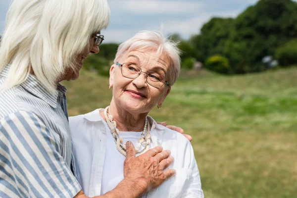 Happy Senior Man Glasses Putting Hand Chest Smiling Wife — Foto de Stock