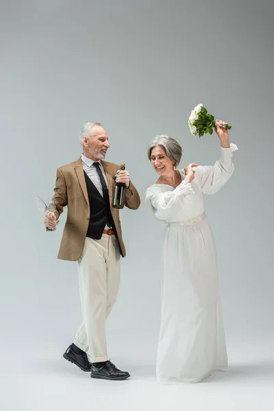 Full Length Joyful Middle Aged Man Holding Bottle Champagne Glasses — Foto de Stock