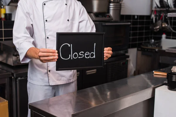 Cropped View Chef Uniform Holding Chalkboard Closed Lettering Kitchen — Stock Photo, Image