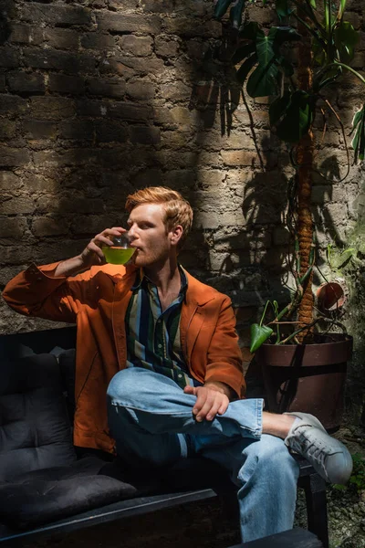 Young Redhead Man Leather Jacket Drinking Green Cocktail — Zdjęcie stockowe