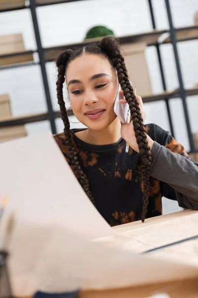 Smiling African American Craftswoman Looking Blurred Paper Talking Cellphone Workshop — Stock Photo, Image