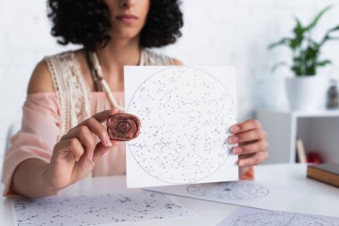 partial view of oracle holding clay rune and constellations map  clipart