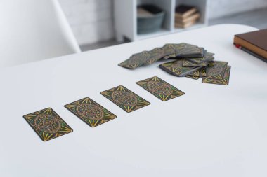 KYIV, UKRAINE - JUNE 29, 2022: high angle view of tarot cards on white table at home