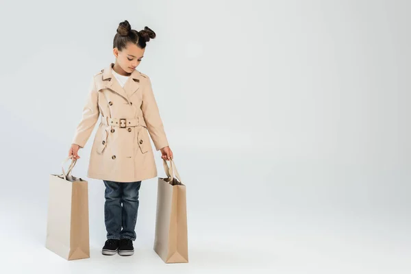 Full Length Stylish Kid Trench Coat Jeans Holding Shopping Bags — 스톡 사진