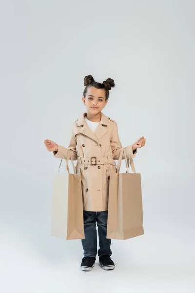 Full Length Stylish Child Trench Coat Jeans Holding Shopping Bags — Stock Fotó