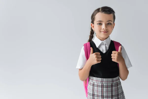 Cheerful Schoolgirl Backpack Standing School Uniform Showing Thumbs Isolated Grey — Zdjęcie stockowe