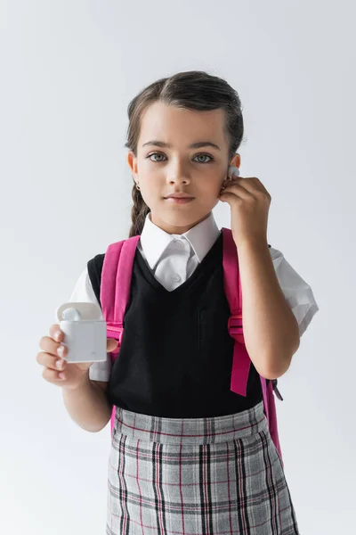 Cute Schoolgirl Holding Earphone Case Listening Music Isolated Grey — Stock Fotó