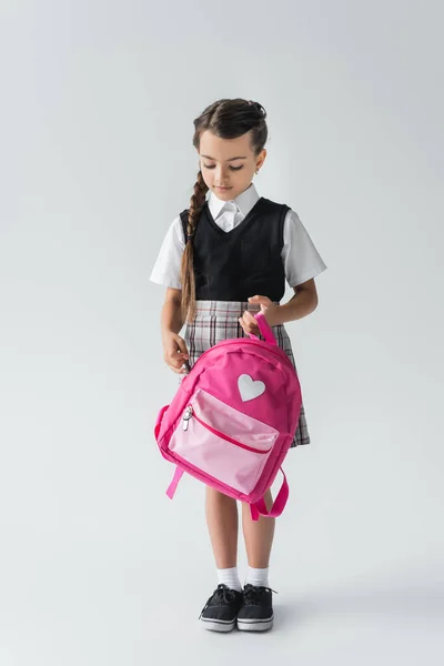 Full Length Cute Schoolgirl Uniform Holding Pink Backpack While Standing — Stok fotoğraf