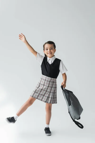 Full Length Adorable Cheerful Schoolgirl Uniform Holding Backpack Grey — стоковое фото