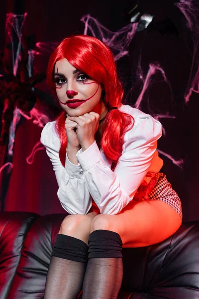 Sexy Woman Clown Costume Looking Camera While Sitting Dark Background — Stock Photo, Image