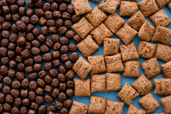 Top View Tasty Chocolate Cereal Balls Puffs Blue — Stock Photo, Image