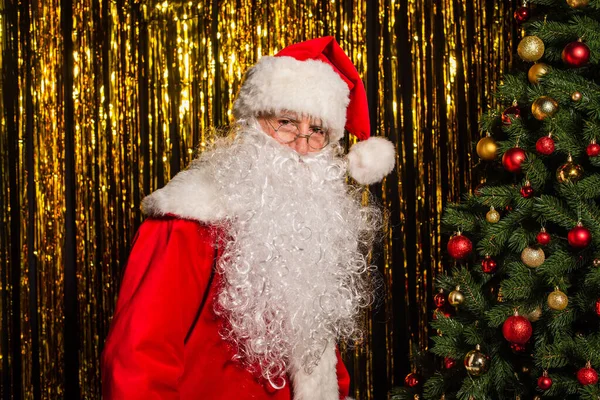 Santa Claus Costume Eyeglasses Looking Camera Christmas Tree Golden Tinsel — Stock Photo, Image