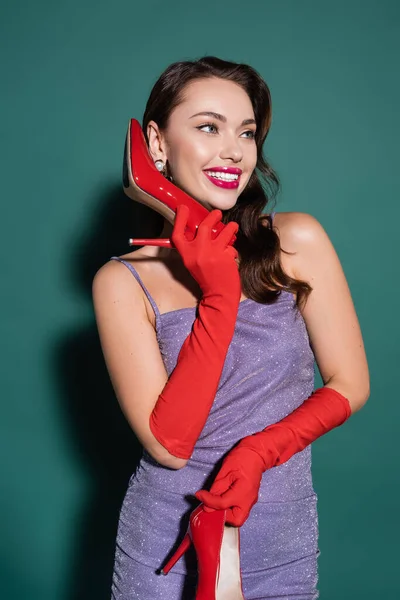 Happy Young Woman Red Gloves Holding High Heeled Shoe Ear — Stock Photo, Image