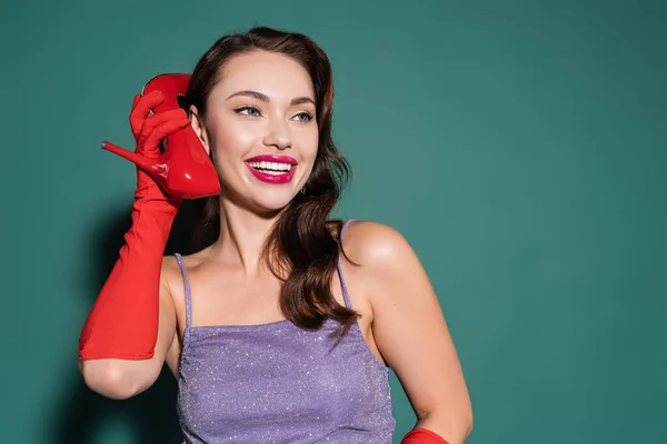 Cheerful Young Woman Red Glove Holding High Heeled Shoe Ear — Stock Photo, Image