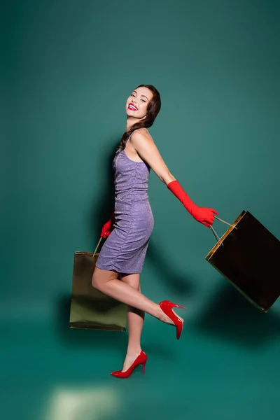 Longitud Completa Mujer Feliz Guantes Rojos Vestido Púrpura Sosteniendo Bolsas —  Fotos de Stock