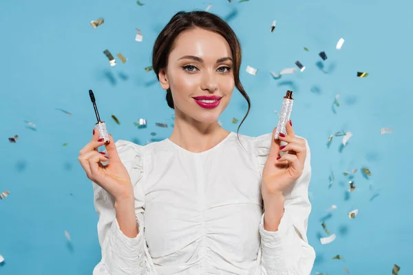 Cheerful Young Woman White Blouse Holding Mascara Smiling Falling Confetti — Stock Photo, Image