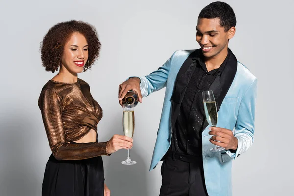 Happy African American Man Pouring Champagne Young Elegant Woman Grey — Stock Photo, Image