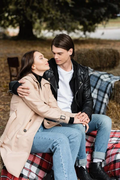 Stylish Man Black Jacket Hugging Girlfriend Trench Coat While Sitting — Stock Photo, Image