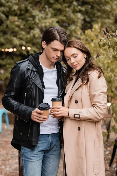 Young Woman Man Stylish Outfits Standing Closed Eyes Holding Coffee — Stock Photo, Image