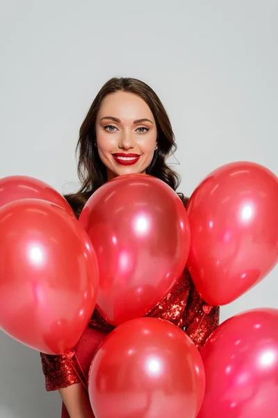 Positive Woman Red Lips Holding Festive Balloons Looking Camera Grey — Stock Photo, Image