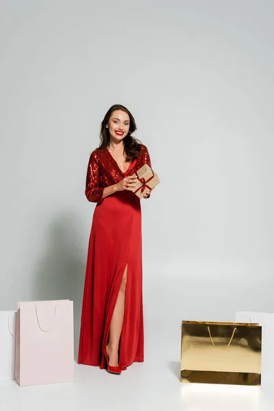 Full Length Trendy Woman Red Dress Holding Gift Box Shopping — Stock Photo, Image