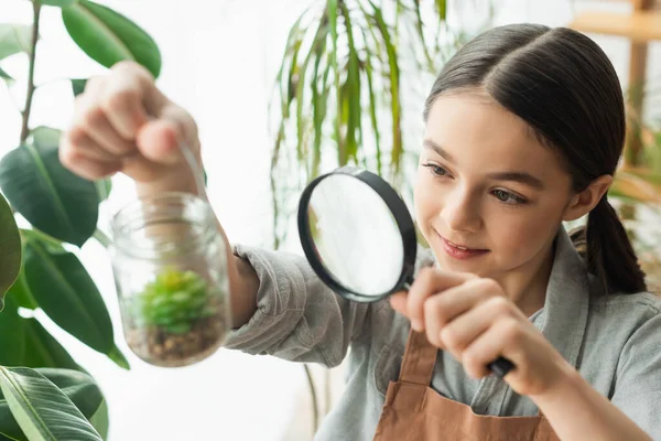 Smiling Girl Holding Magnifying Glass Blurred Jar Succulent Home — Stock Photo, Image