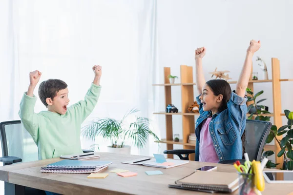 Niños Emocionados Mostrando Gesto Ganar Cerca Cuadernos Notas Papel Mesa —  Fotos de Stock