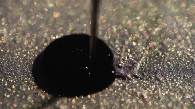 Close up view of nail polish pouring on sparkling eye shadow  clipart