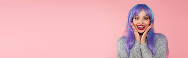 Cheerful woman with dyed hair looking at camera isolated on pink, banner — Stock Photo