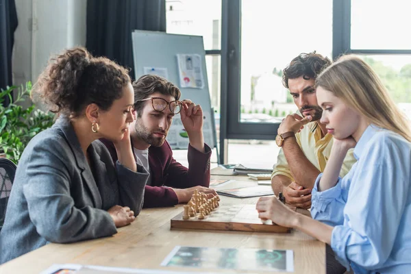 Multiethnische Geschäftsleute spielen Schach im Büro — Stockfoto