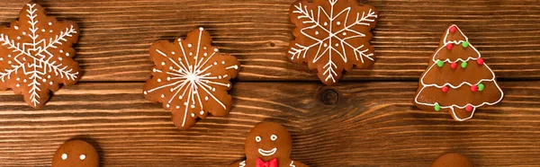 Top view of gingerbread cookies on wooden surface, banner — Stock Photo