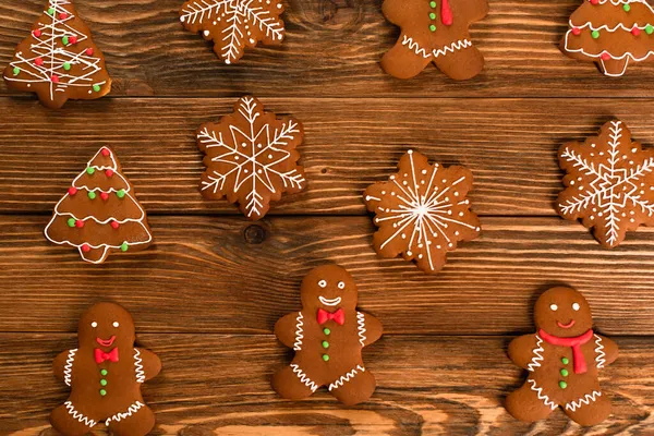 Top view of gingerbread cookies on wooden surface — Stock Photo