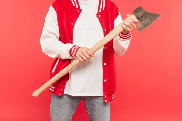 Cropped view of man holding axe isolated on red — Stock Photo