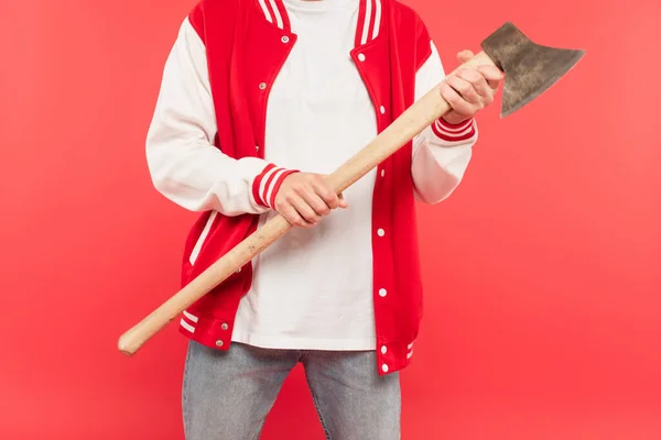 Cropped view of man holding axe isolated on red — Stock Photo