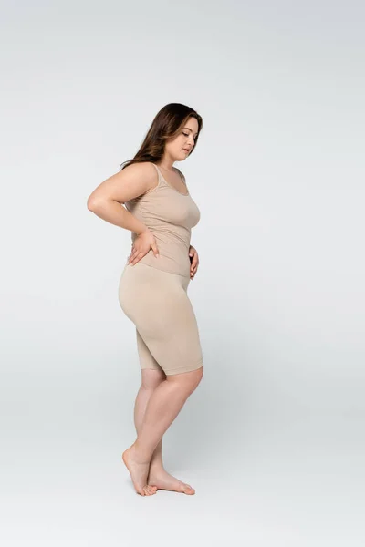 Full length of body positive woman standing on grey background — Stock Photo