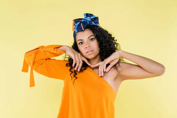 Jolie femme américaine africaine en mouchoir posant isolée sur jaune — Photo de stock