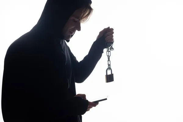 Side view of hacker using smartphone and holding padlock isolated on white — Stock Photo